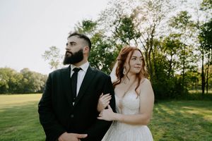 A wedding couple shares candid moments during their outdoor photo session at golden hour.