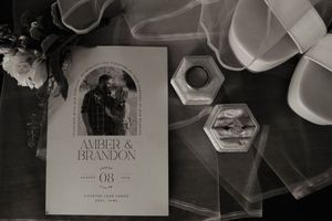 Wedding stationery and invitation cards arranged in an artistic black and white composition.