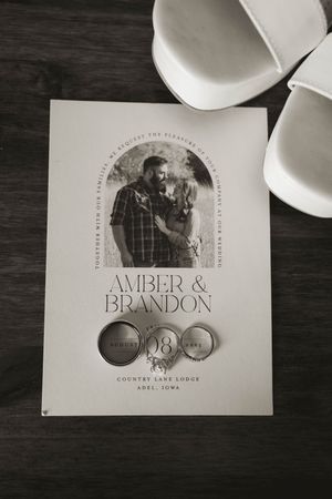 Black and white wedding invitation featuring elegant typography and design elements.