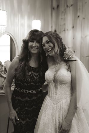Natural light wedding preparation scene with laughter and joy.