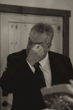 Emotional moment captured in black and white at formal event.