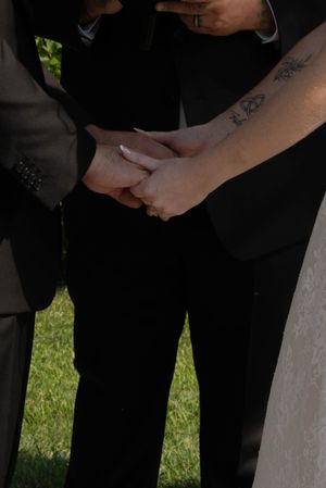 Close-up detail of hands during a wedding ceremony.