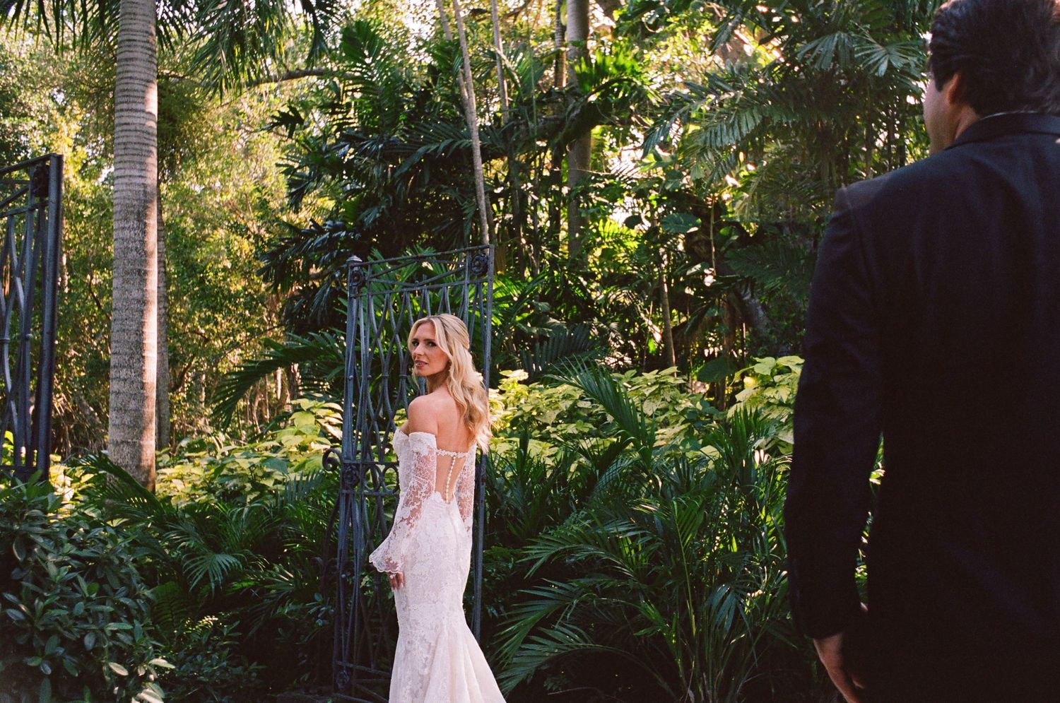A beautiful outdoor engagement photo session in a lush garden setting with natural lighting and greenery.