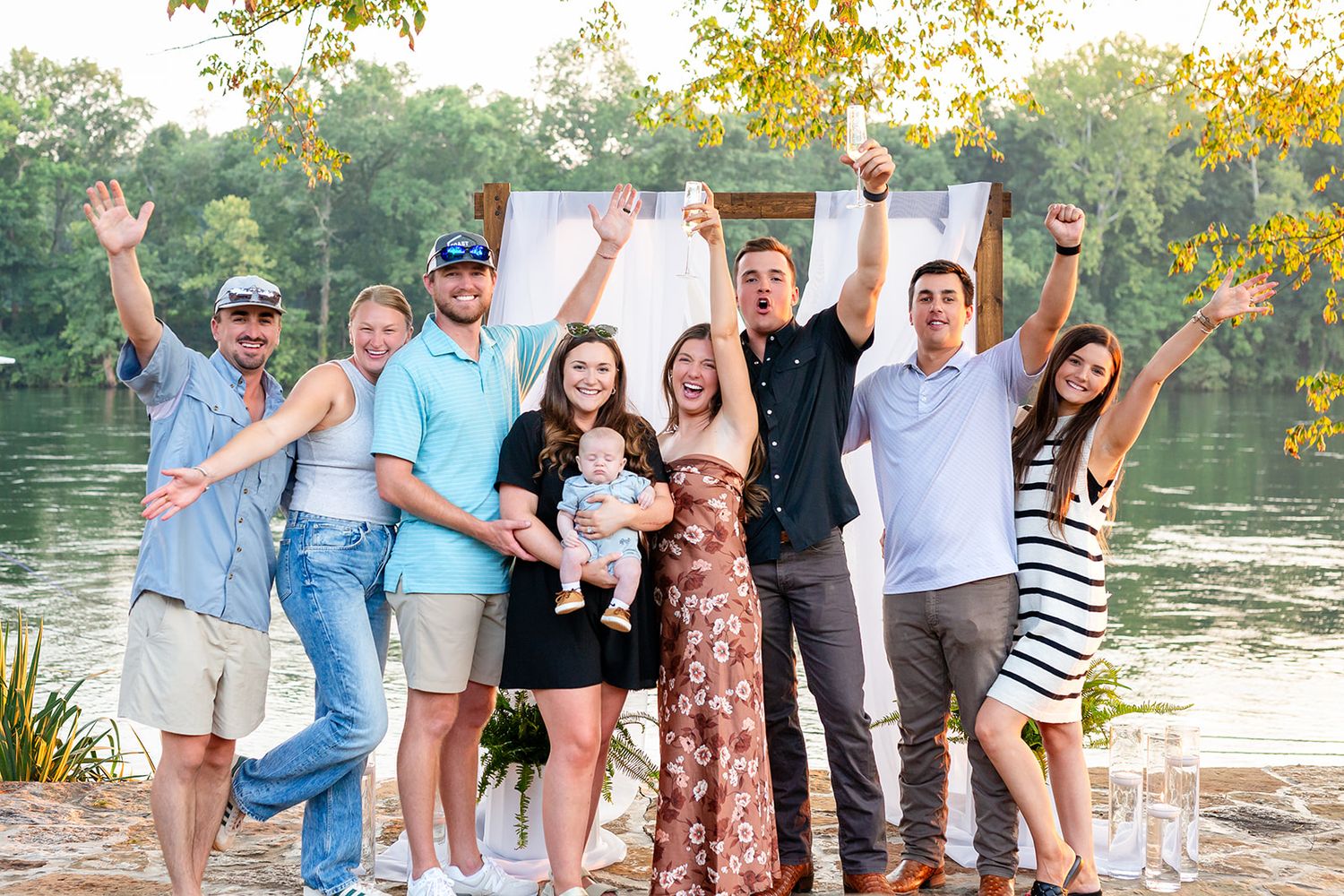 Friends and family cheer with the newly engaged couple by the White River in Cotter, Arkansas.