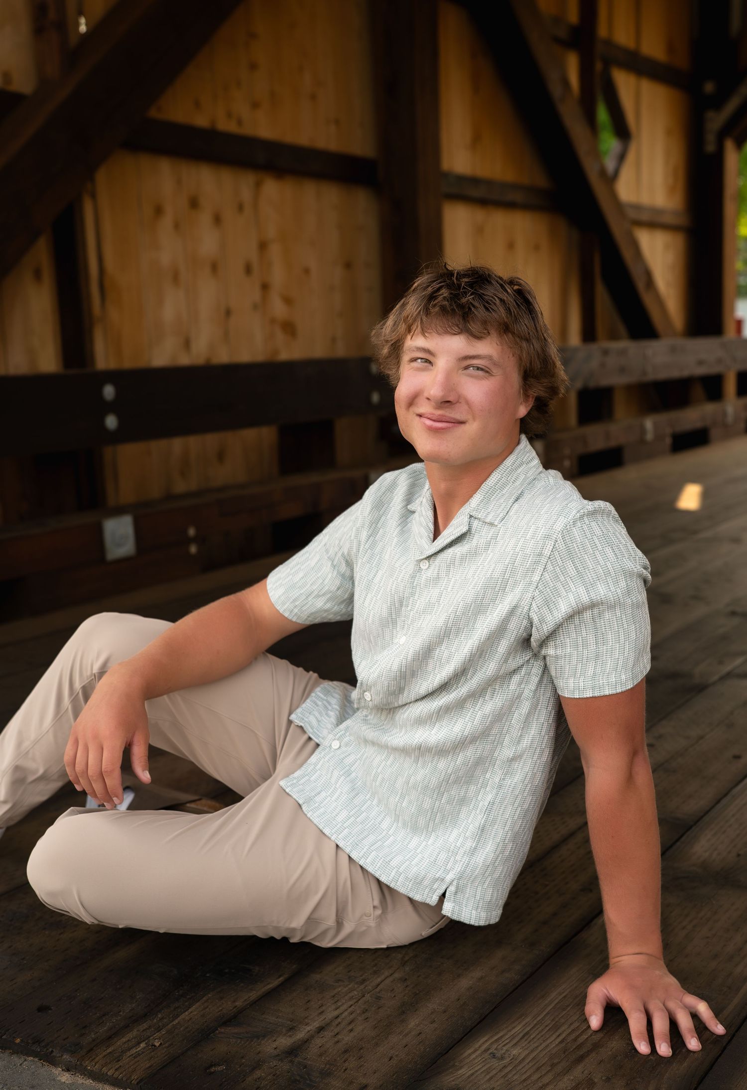 Series of casual portrait poses on a wooden surface in a rustic setting showing relaxed and natural expressions.