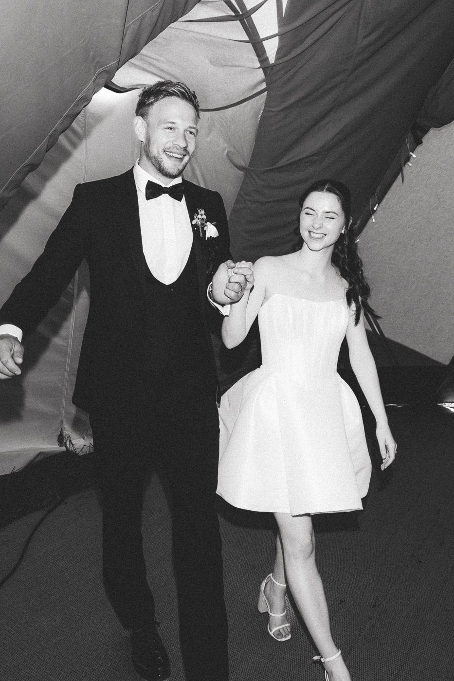 Black and white photo sequence shows a couple in formal attire dancing joyfully together at a celebration.