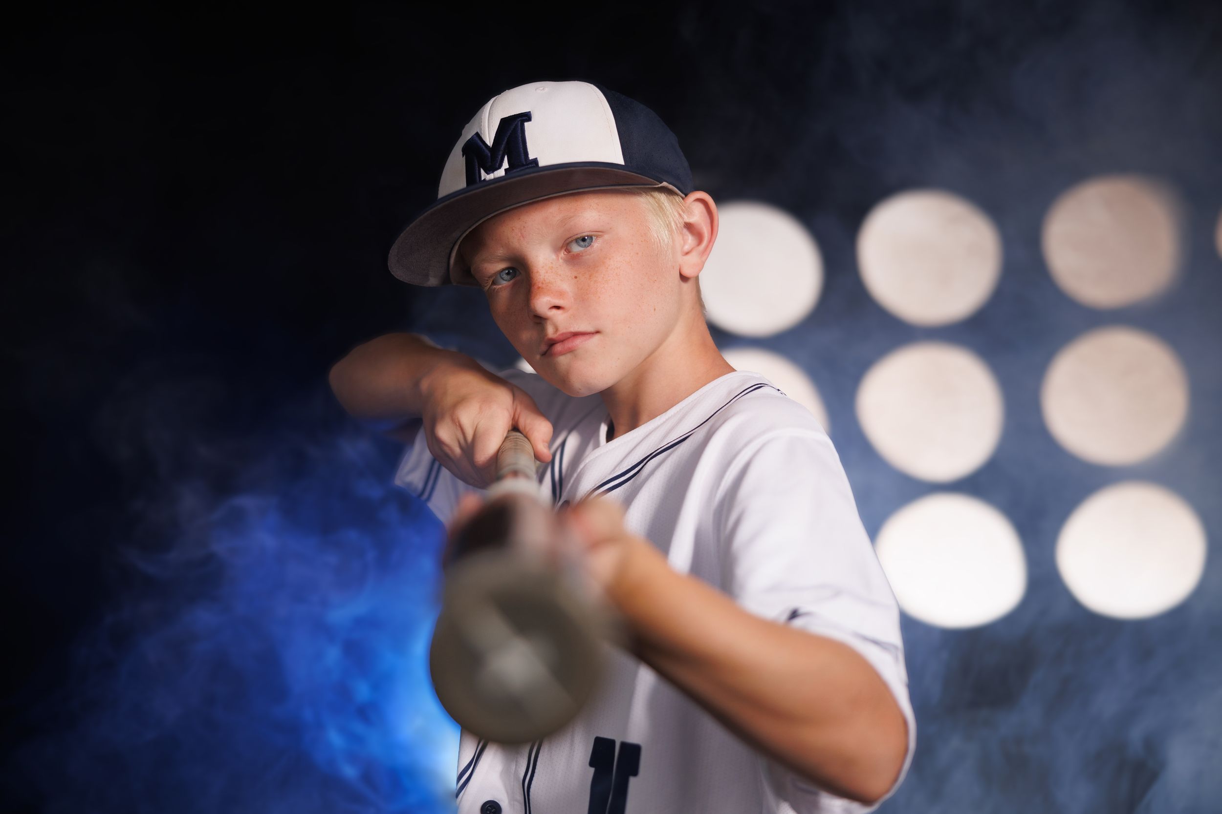 Baseball player portraits with dramatic stadium lighting and bokeh effects in blue tones.