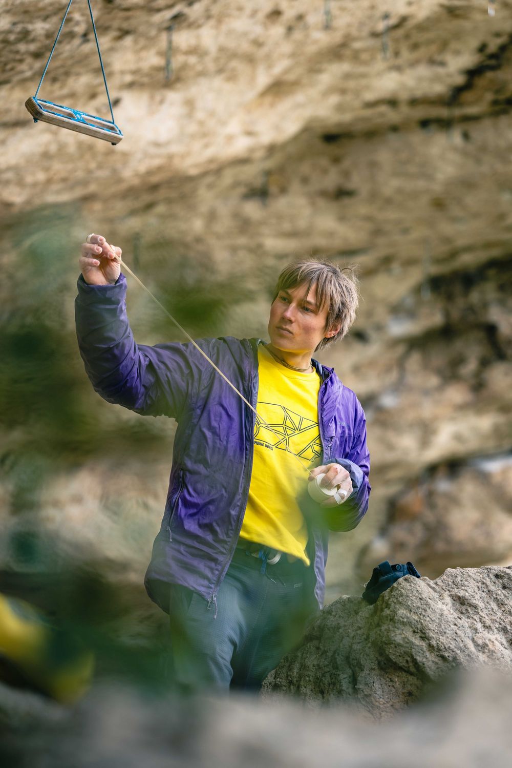 Alex Megos taping his fingers in Buoux, France. Photo Jan Virt.