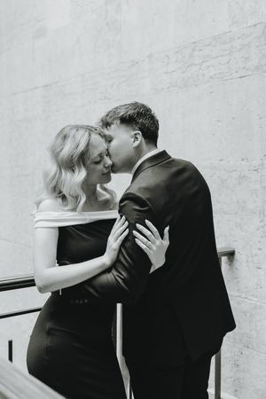 Black and white sequence of romantic moments against a white wall.