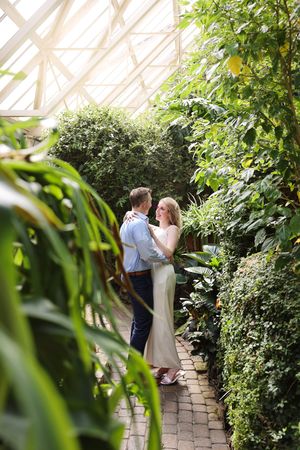 Romantic greenhouse wedding photos surrounded by lush greenery and natural light.