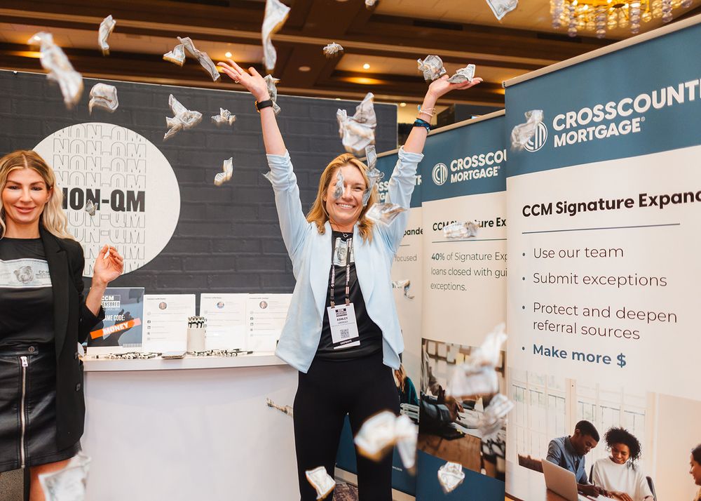 Business event celebration with confetti flying in air at CrossCountry Mortgage presentation.