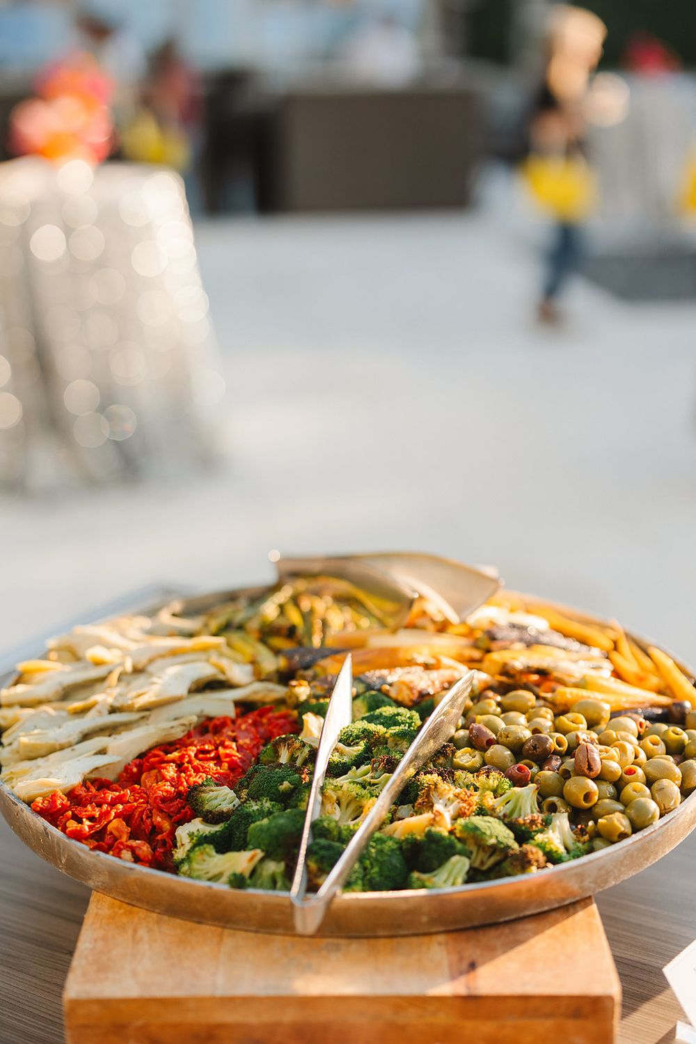 Fresh colorful salad bowl with chickpeas, vegetables and greens arranged in organized sections.