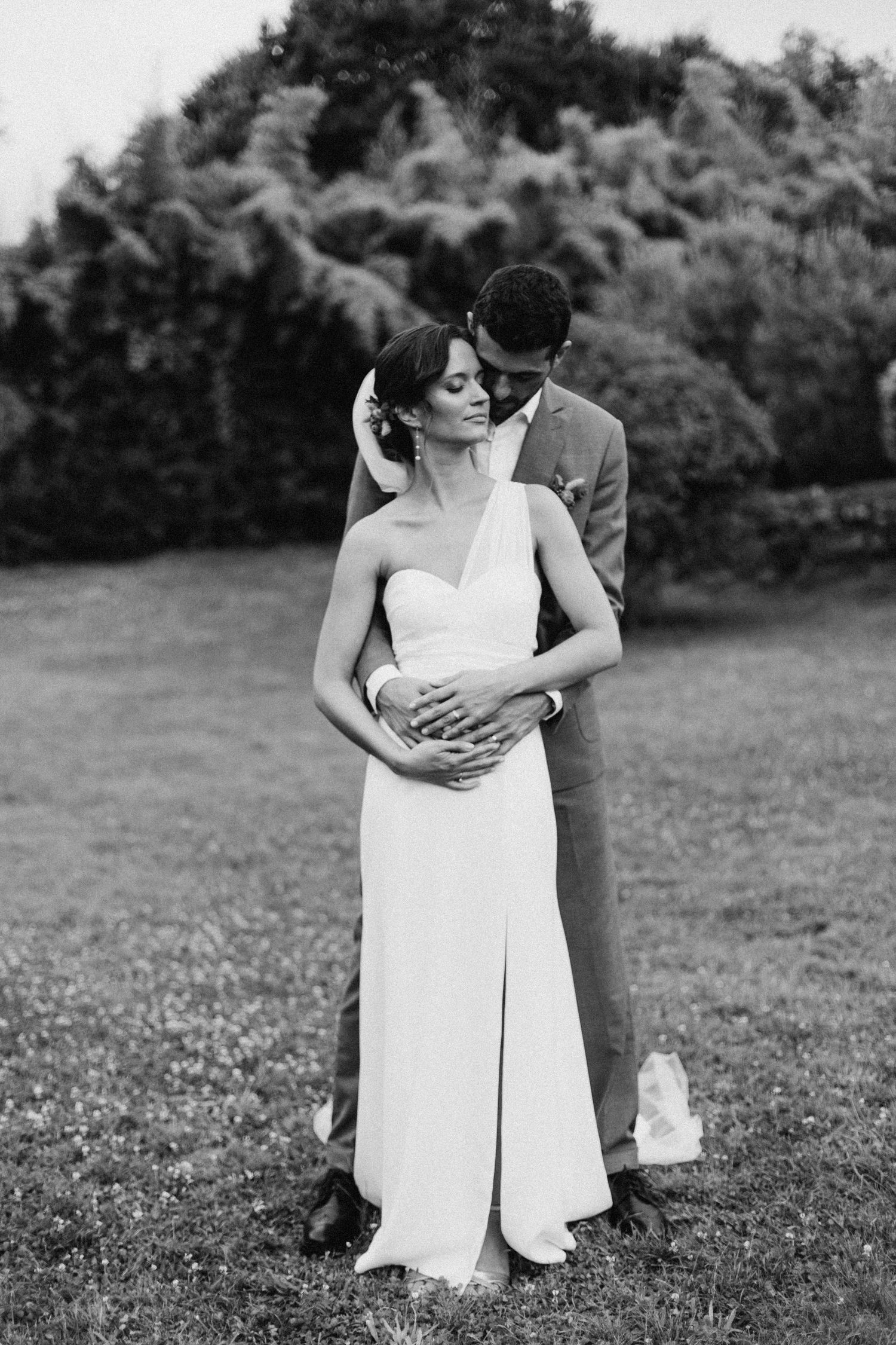 A tender autumn embrace captured during a wedding photoshoot with fall foliage.