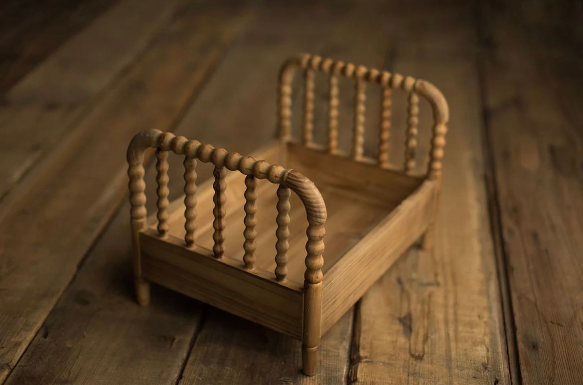 A collection of six images showing wooden fence goose neck spindles arranged in various positions on a rustic wood surface.