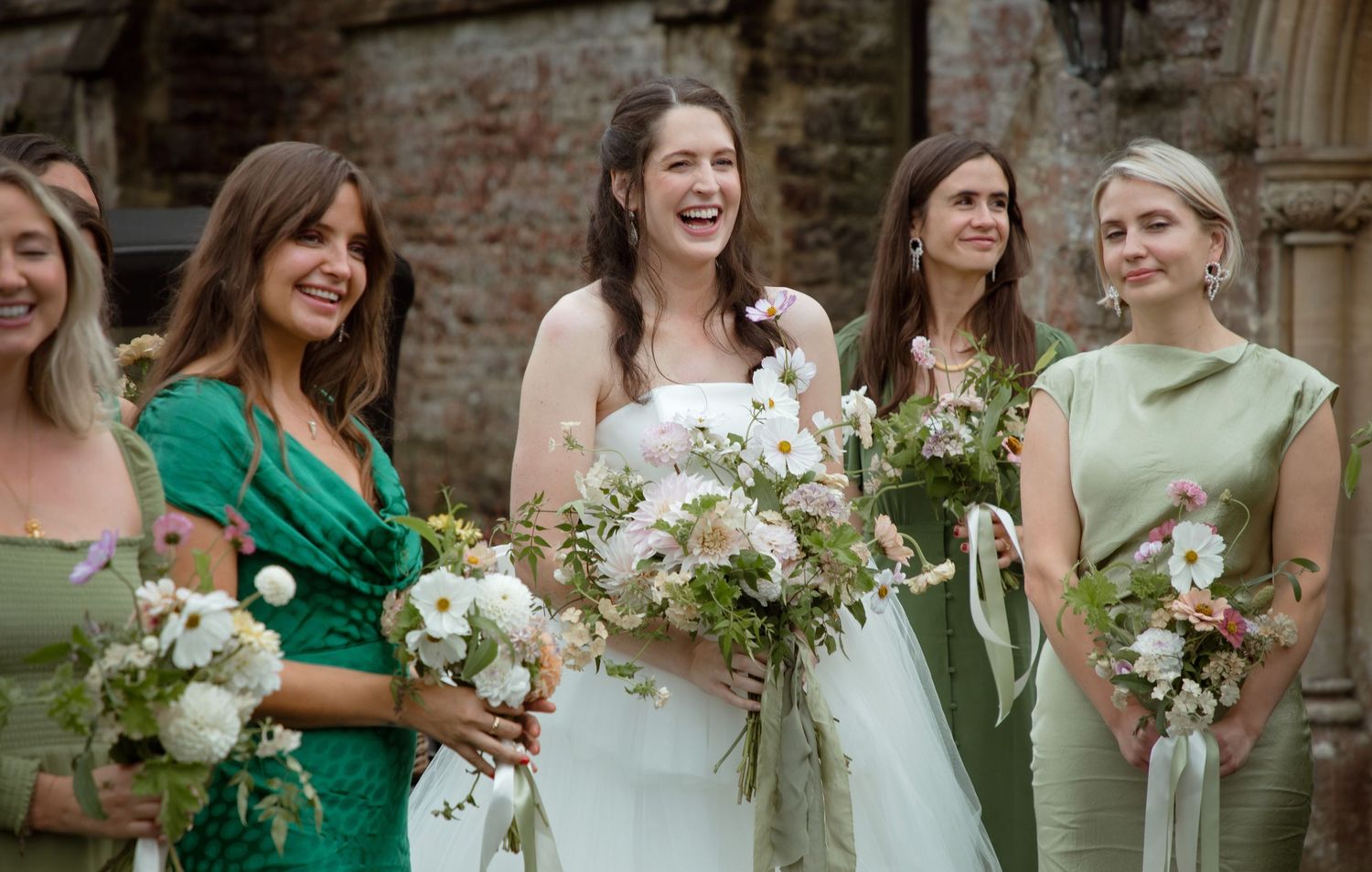 bride and bridesmaid fun love laughter bouquet wild flowers floral professional photography luxury wedding