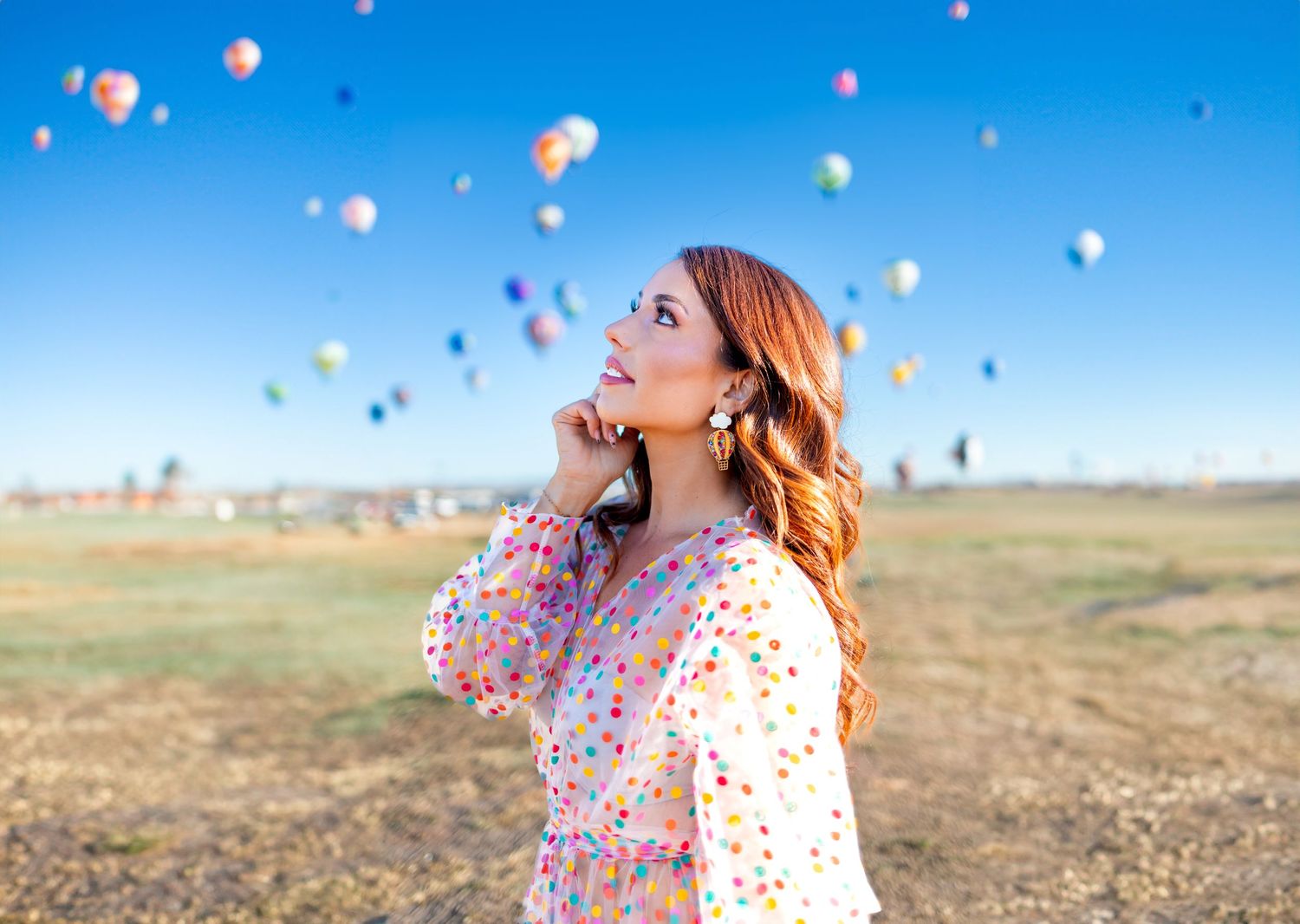 A joyful scene with colorful hot air balloons floating in a bright blue sky background.