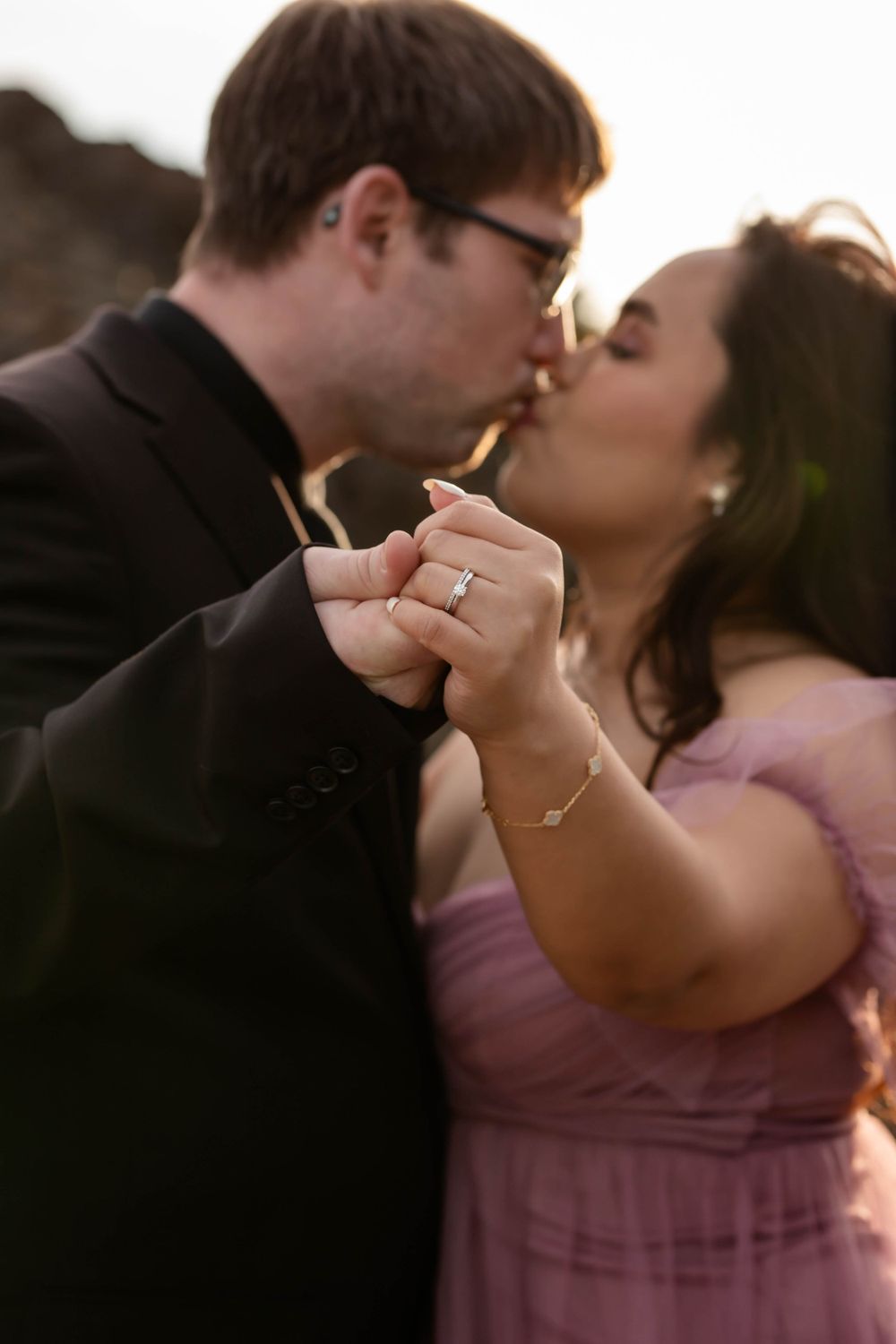 An intimate moment captured between a couple holding hands during their engagement photoshoot.