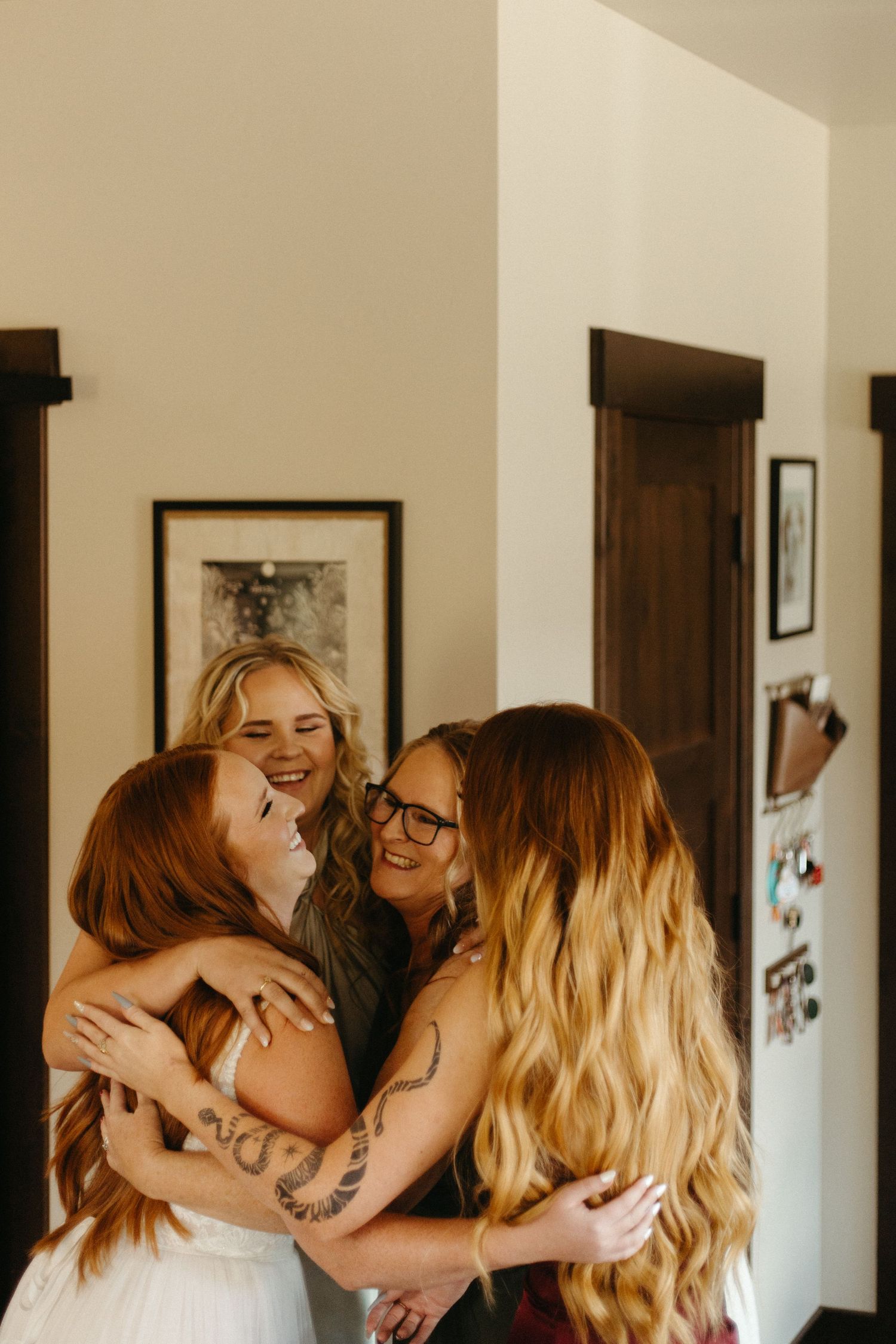 Joyful emotional embrace shared between friends in a warmly lit hallway.