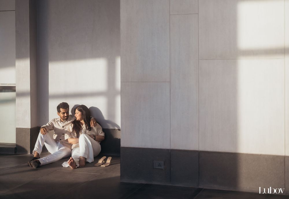 Intimate indoor portrait session with natural window lighting creating dramatic shadows.