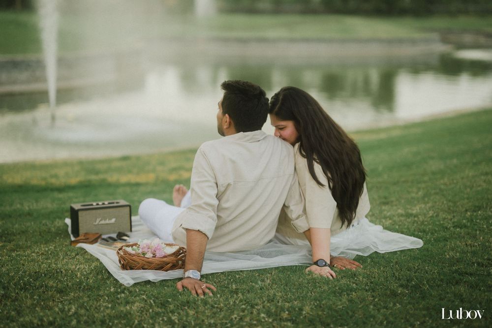 Peaceful afternoon picnic by a lake with reflection on the water's surface.