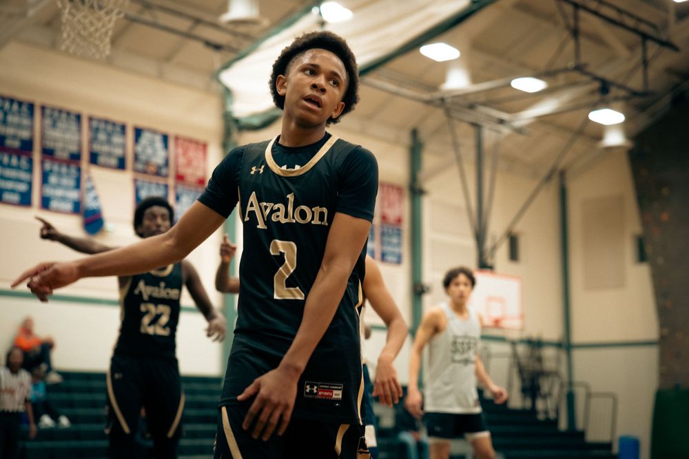 Player #2 in Avalon basketball jersey reacts during an indoor high school basketball game.