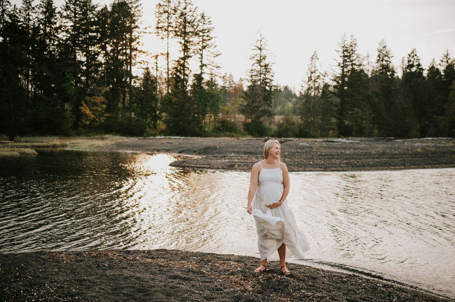Outfit inspo for your Vancouver Island photoshoot? This maternity client wore a flowy cream dress on a black sand beach in the summer