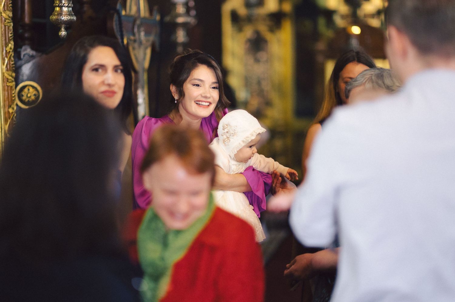 A festive gathering with people in colorful attire including pink and red during what appears to be a special occasion.