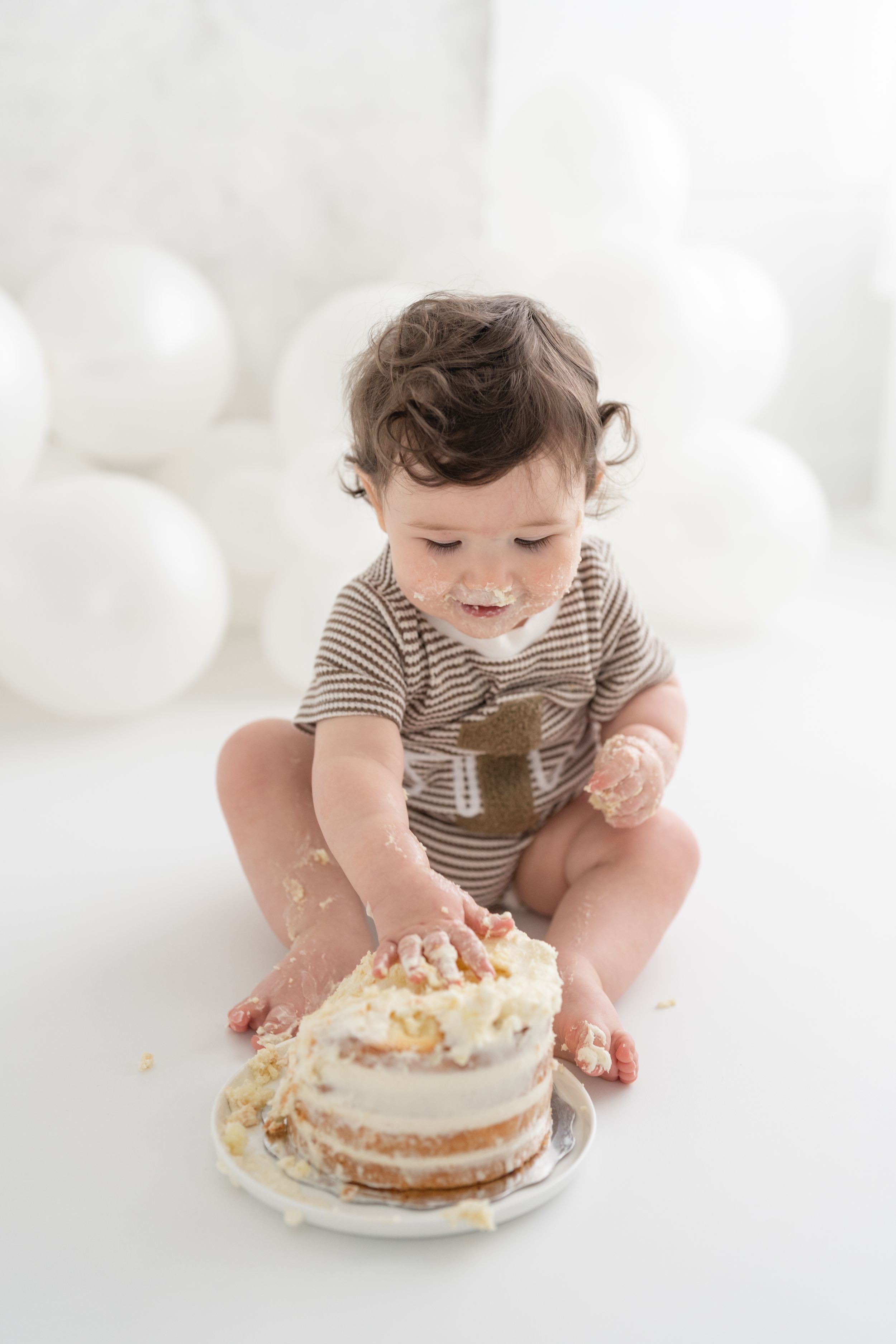 Bébé assis au sol avec un gâteau pour sa séance anniversaire smash the cake au studio de Saint-Augustin-de-Desmaures, Québec, Portneuf