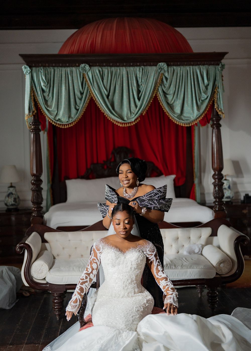 A bridal portrait session in a luxurious bedroom featuring elegant draped curtains and a grand four-poster bed.