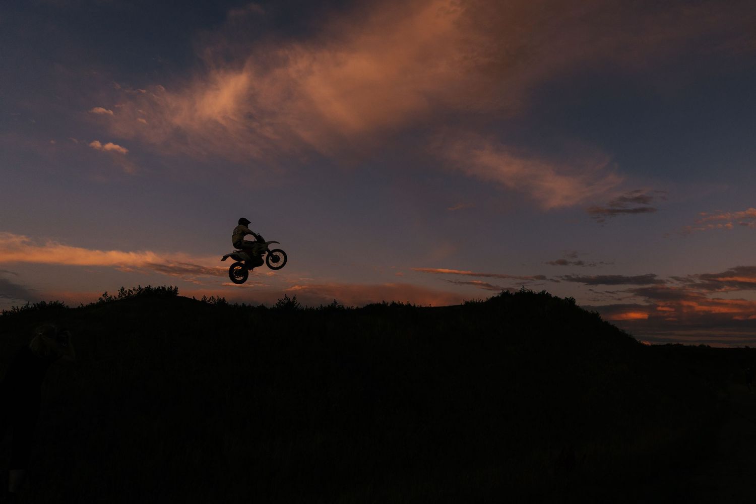 Vehicle silhouette with glowing LED lights against night sky backdrop.