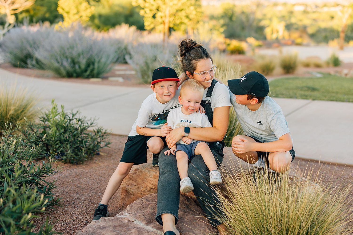 Anna hugging her boys on a rock at a park in St. George Utah