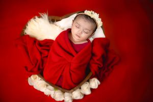 Bhaire Photography newborn portraits from Frisco to all over  Dallas TX, baby resting in cozy home setup.