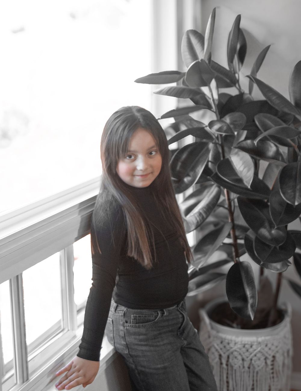 A person in a black top poses near a window with a potted plant, shown from three different angles.