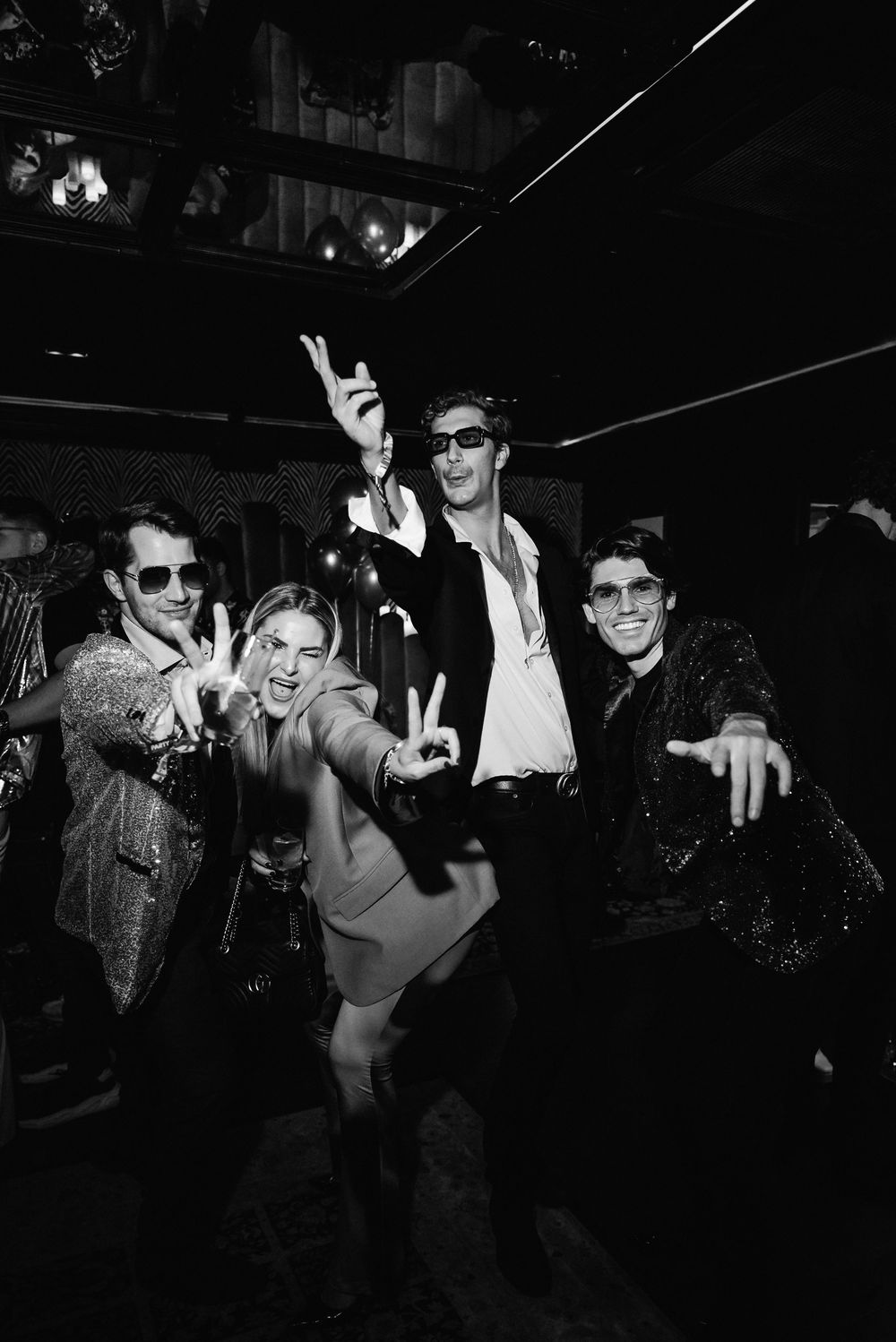 A black and white photo sequence showing people dancing and having fun at a dark nightclub or party.