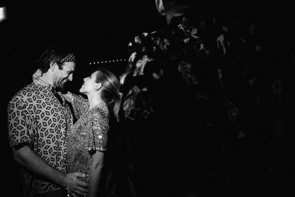 A black and white photo series shows a couple dancing together in what appears to be a romantic celebration setting.