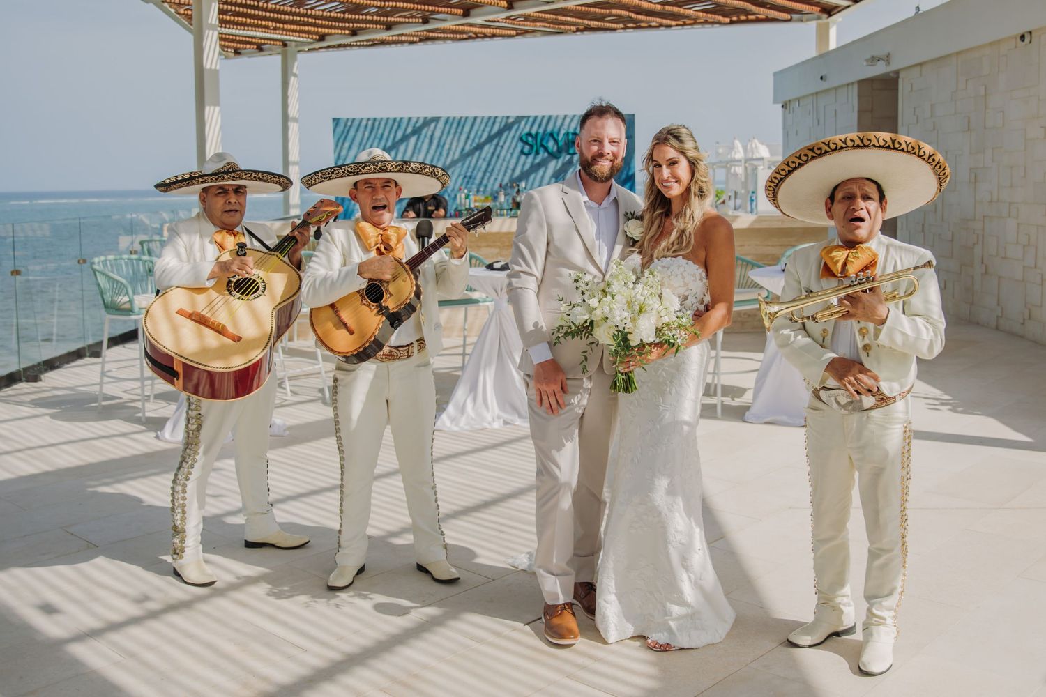 A mariachi band performs at a sunny beachfront wedding Dreams Sapphire Riviera Maya Wedding Photography