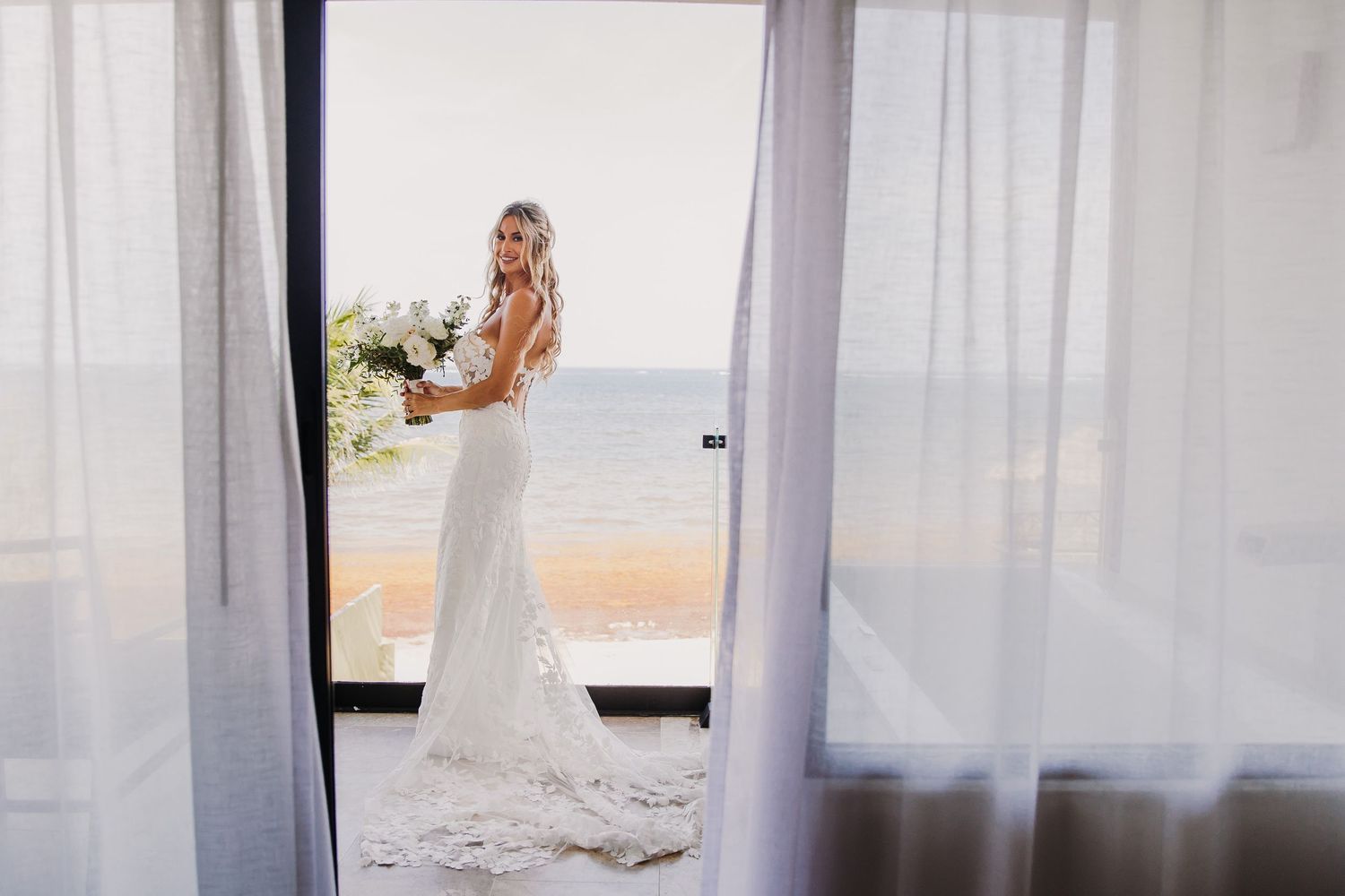 Modern wedding venue interior with flowing white curtains and natural light. Dreams Sapphire Riviera Maya Wedding Photography