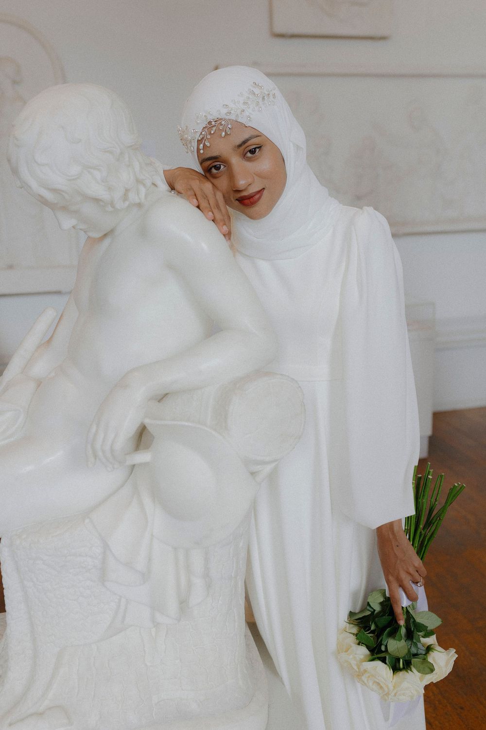 A series of intimate wedding photos showing a couple in traditional white and black attire embracing during their ceremony.