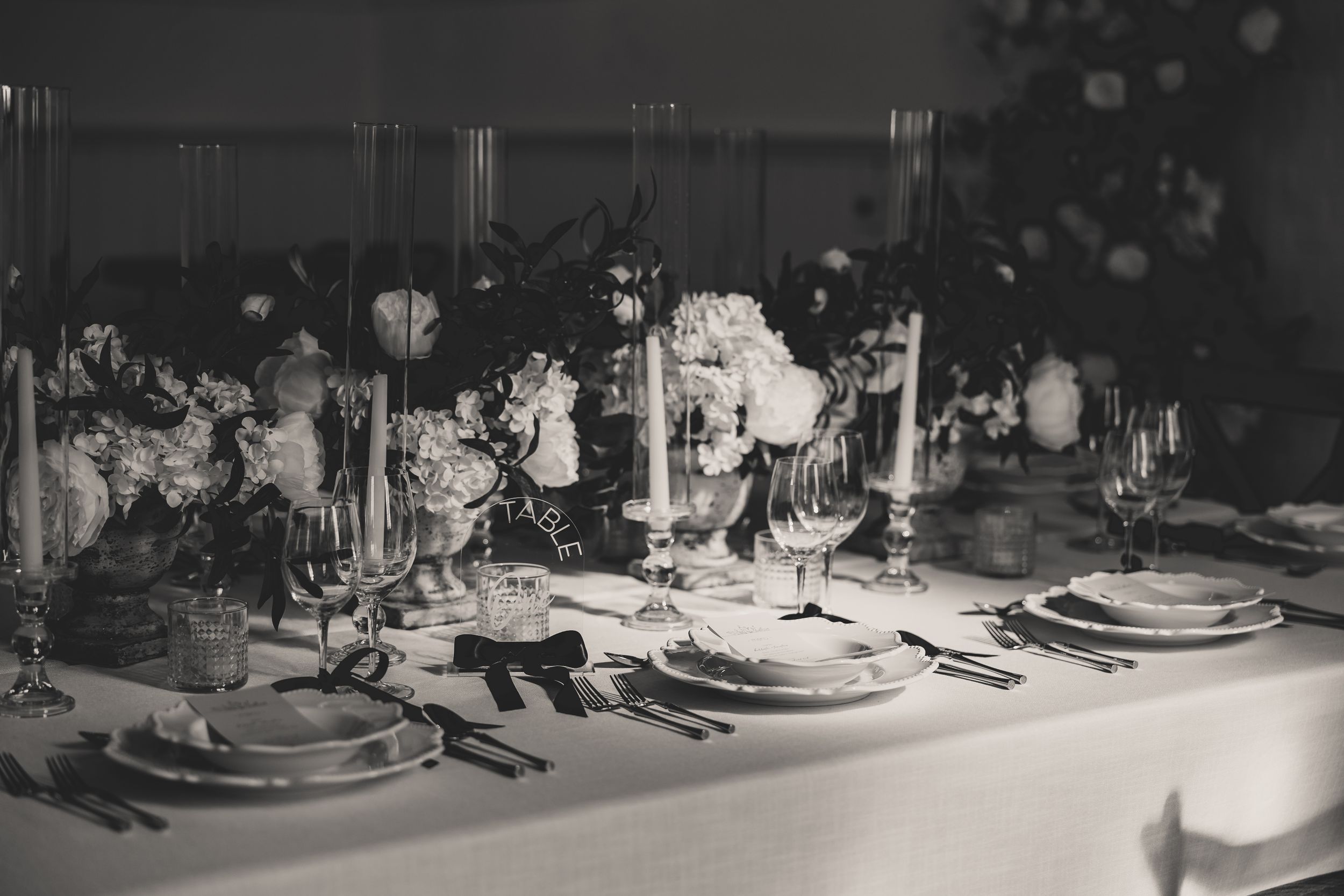 Vintage black and white photograph showing wedding decor on tables.