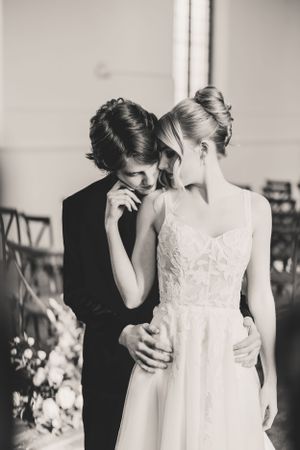 Black and white wedding photo series showing tender moments between a couple in formal attire.