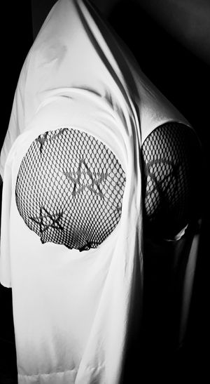 Black and white photo showing textured fabric detail with geometric mesh pattern.