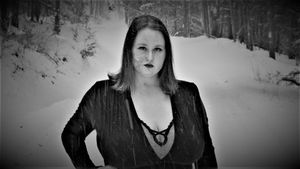 Black and white winter forest portrait with dramatic lighting.