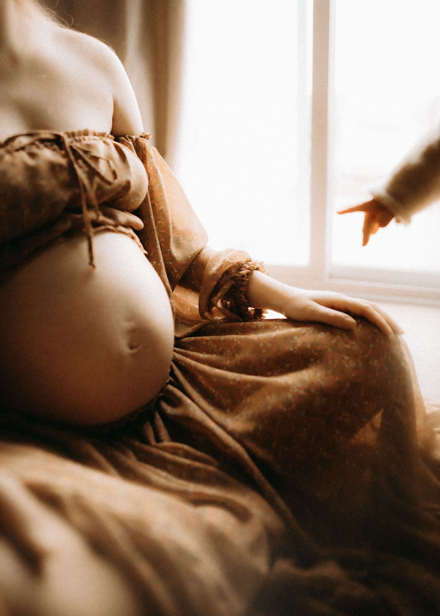Sepia-toned artistic photo series showing gentle movements and curves in soft lighting.