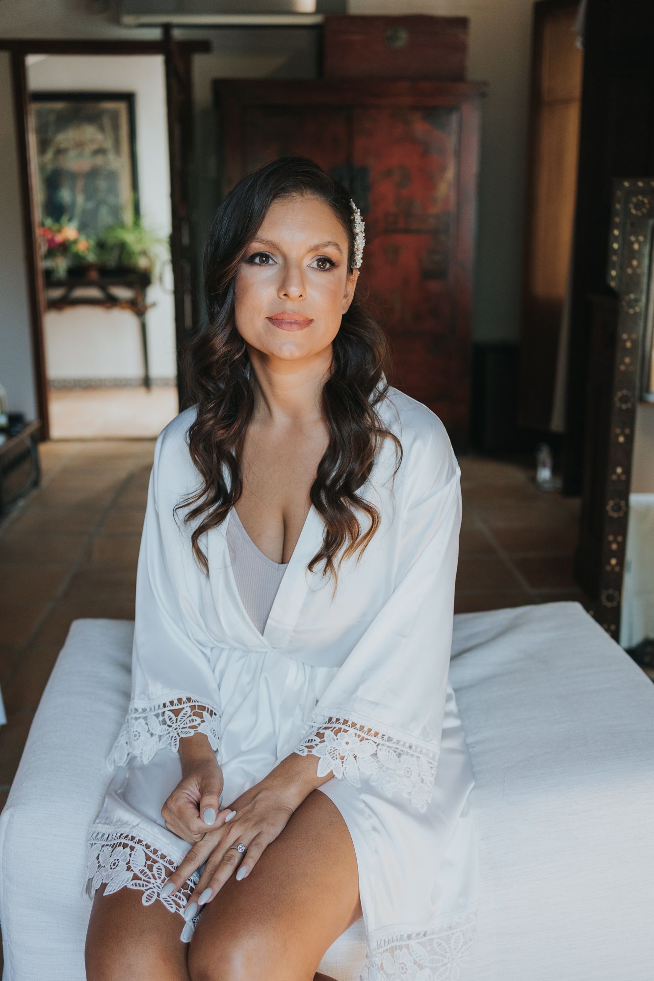 A relaxed morning preparation scene showing a white lace robe in an elegantly decorated interior space.