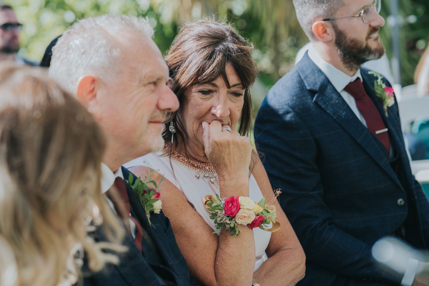 An emotional moment captured during a wedding ceremony with guests sharing laughter and joy.