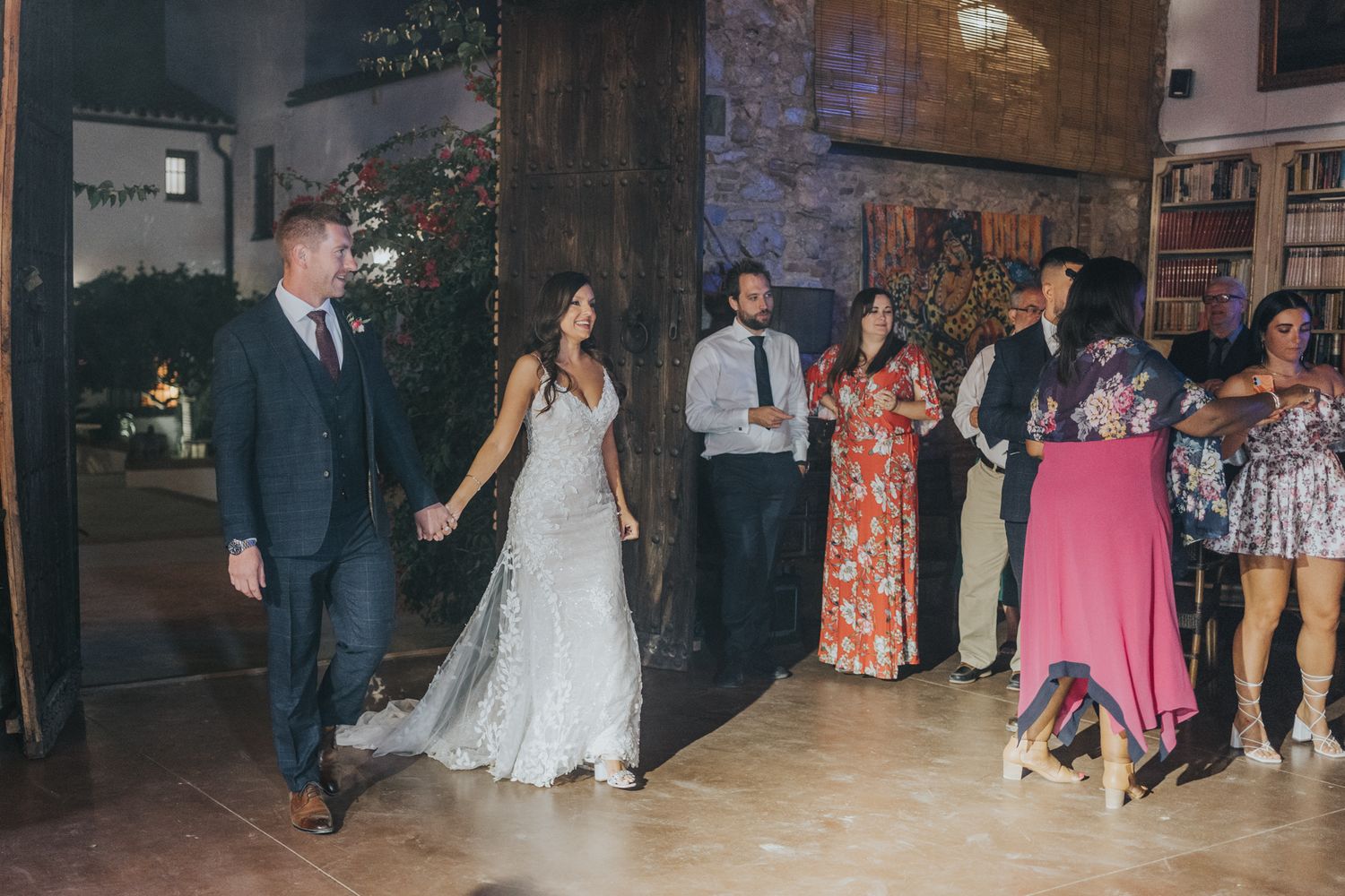 Wedding celebration on a dance floor with guests enjoying festivities in formal attire.