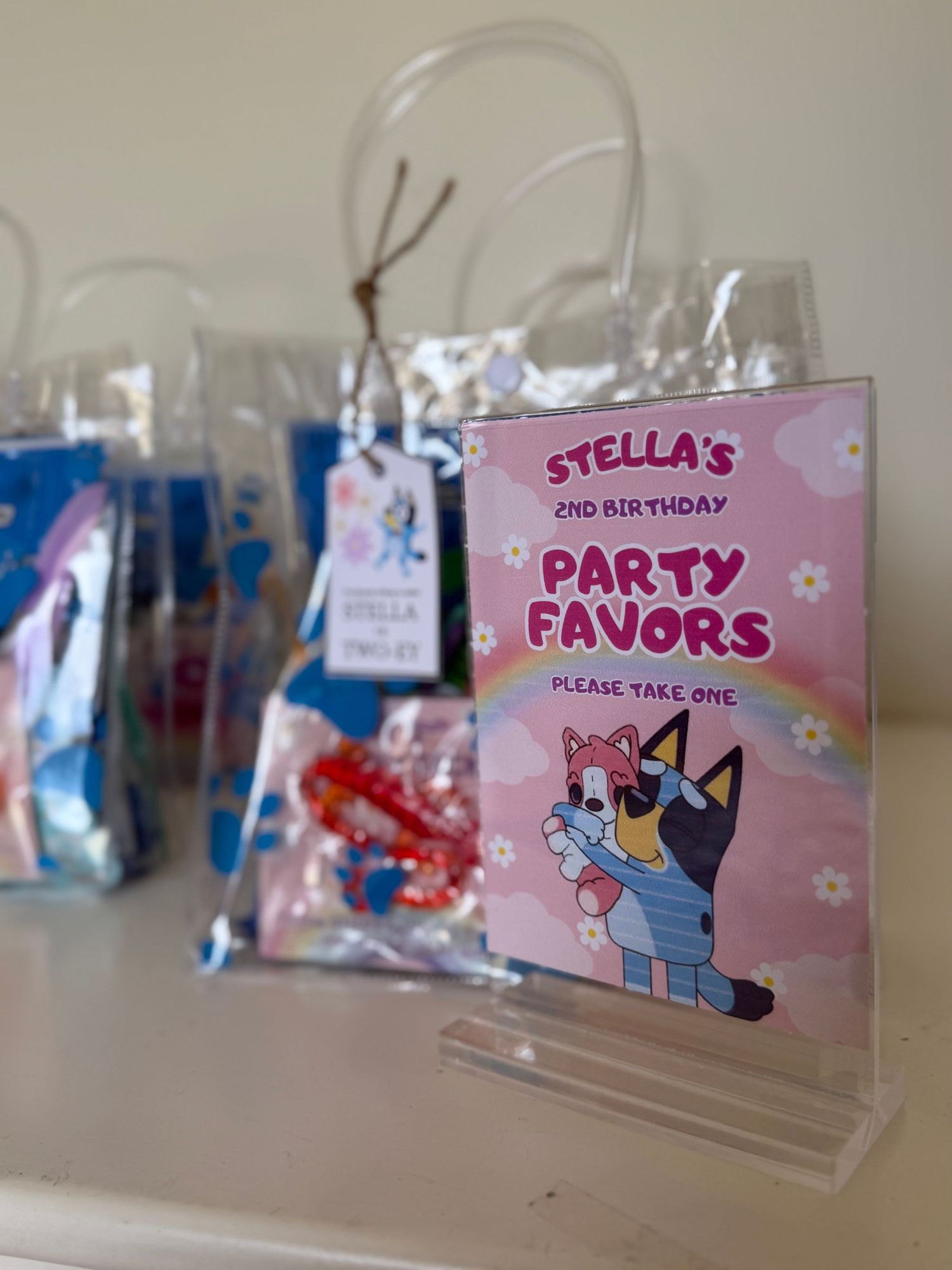 Birthday party favor bags with Bluey themed tags and decorative elements.