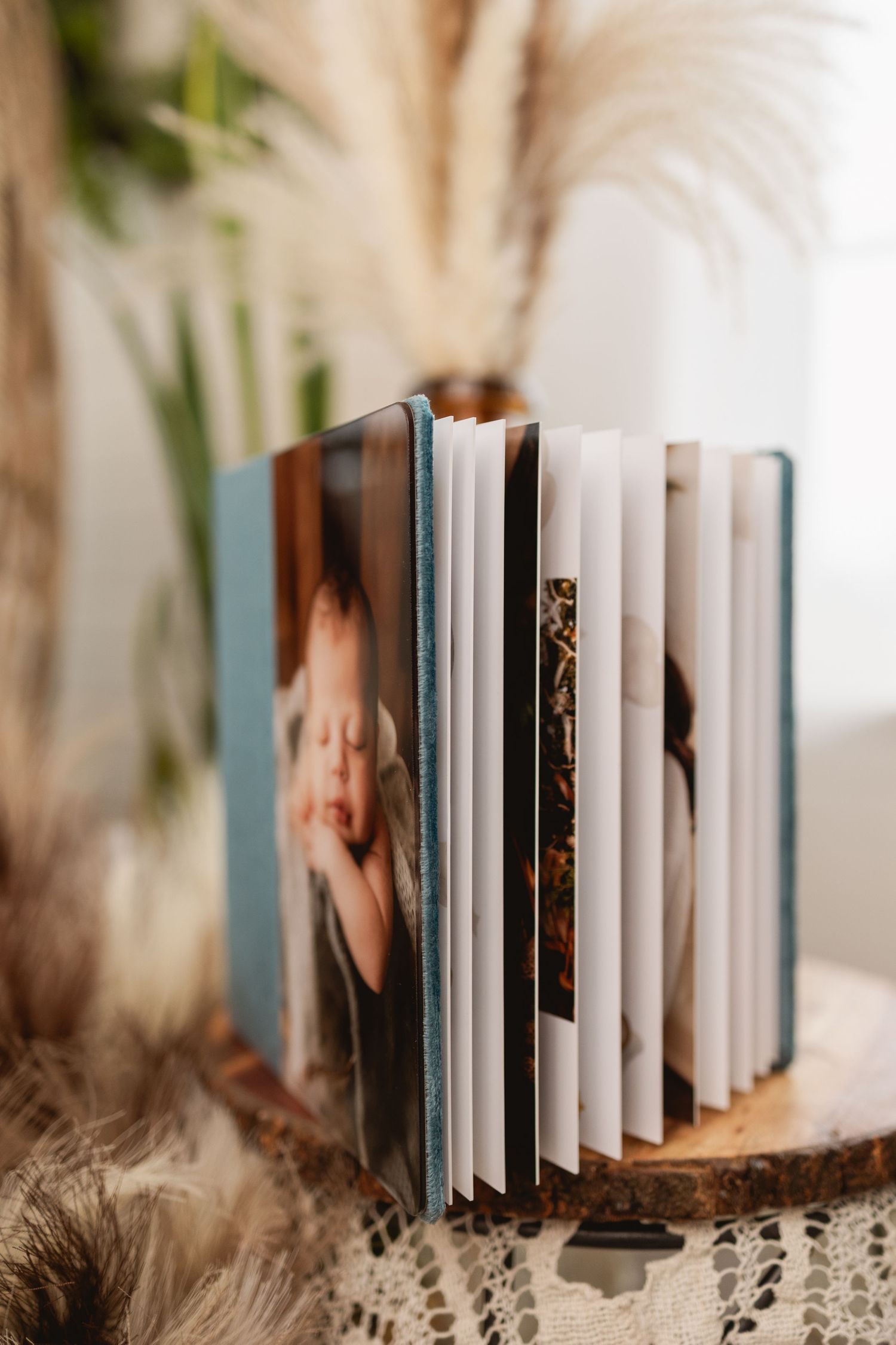 Custom photo album with family portraits, available through Urso Photography’s product line.