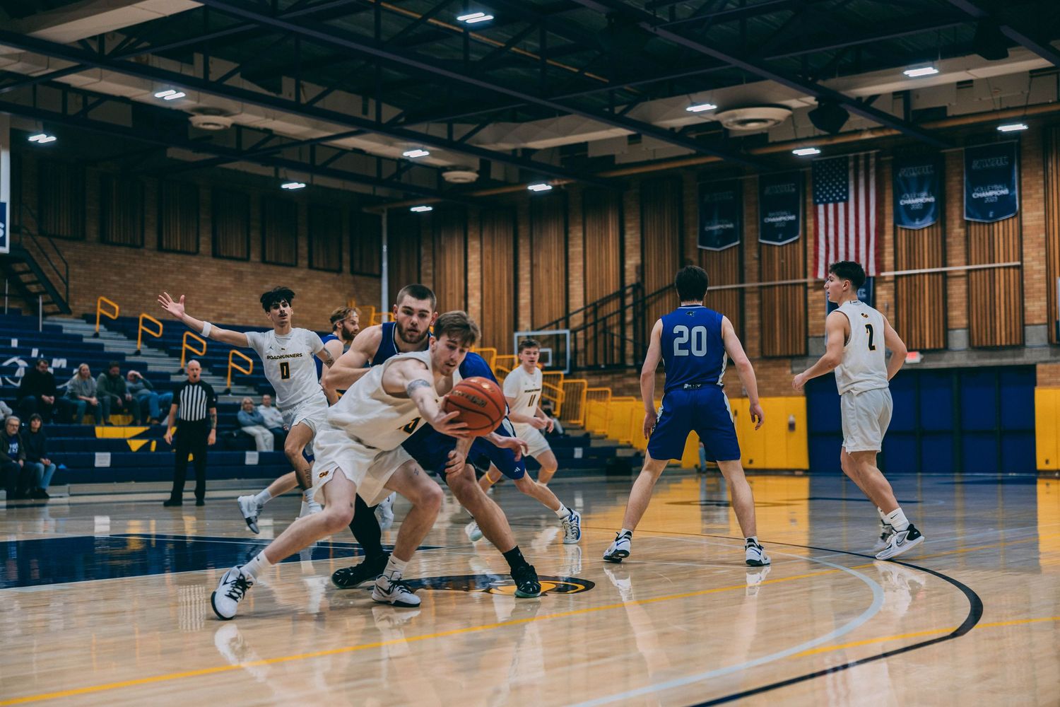 Basketball players compete on the court during an intense game moment.