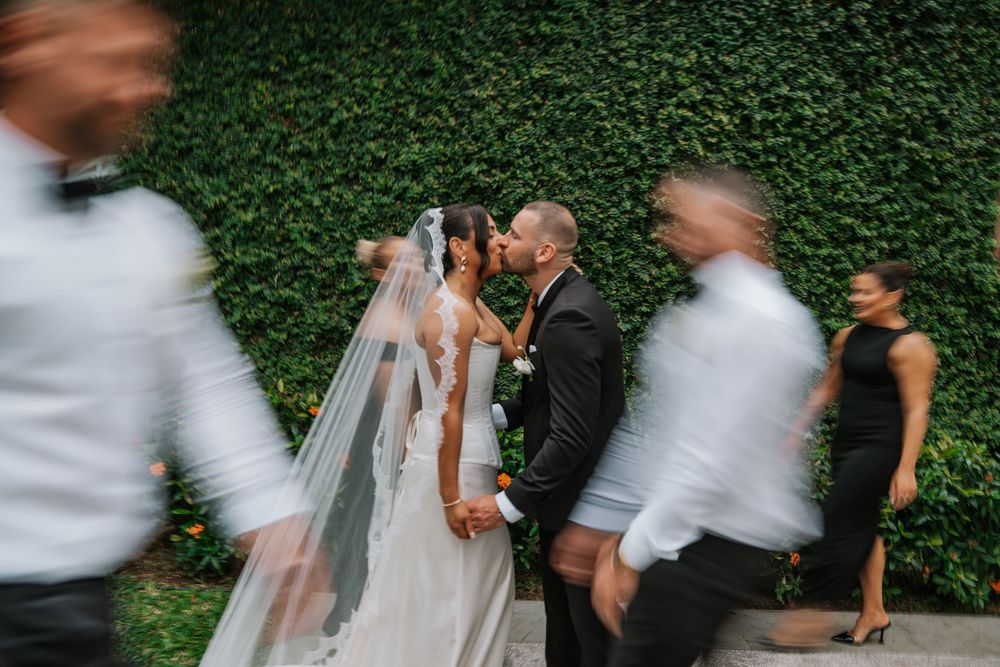 A sequence of romantic wedding photos showing couples dancing and embracing in front of a lush green hedge backdrop.